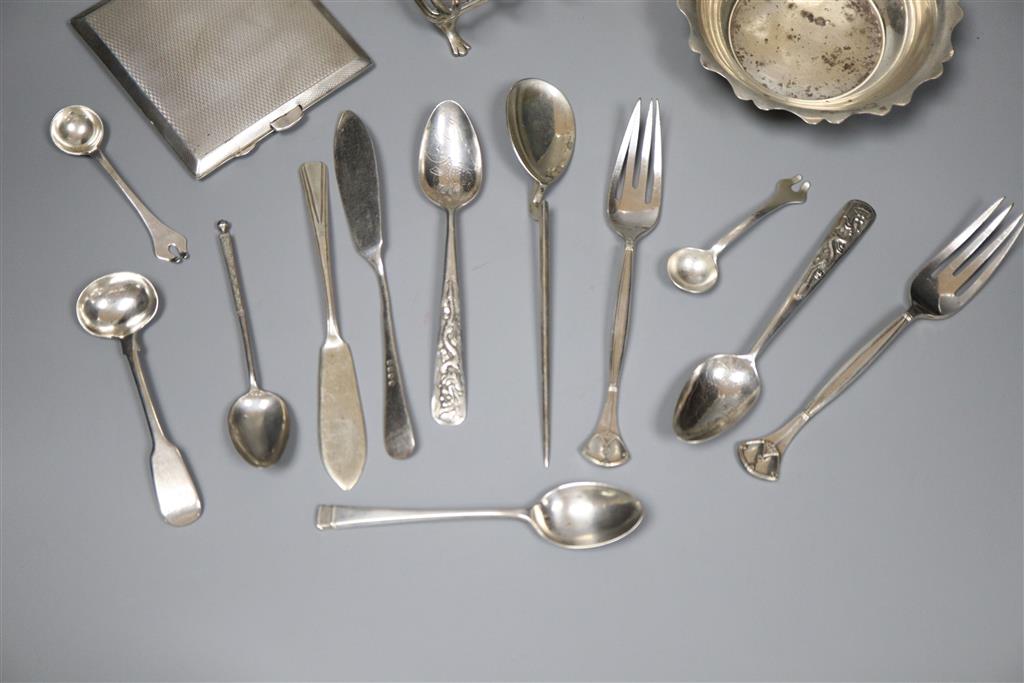 An early 20th century silver toastrack, a silver bowl, silver cigarette case and minor flatware including silver and plated.